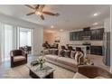 Stylish living room showcases modern furnishings, seamless flow to dining area, and a view of the patio at 14007 Picard Aly, Winter Garden, FL 34787