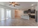 Open-concept living space with sleek tile flooring, abundant natural light, and access to outdoor patio at 14007 Picard Aly, Winter Garden, FL 34787