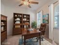 Home office featuring built-in bookshelves, a desk, and natural light from the window at 14007 Picard Aly, Winter Garden, FL 34787
