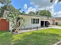 Charming single-story house with well-kept lawn and shaded carport with extra parking space at 1428 Glendale St, Lakeland, FL 33803