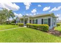 Traditional home with green lawn, manicured bushes, symmetrical windows, and a covered porch at 157 Bell Tower E Xing, Kissimmee, FL 34759