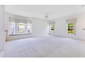 Bright, neutral living room with large windows and plush carpeting, bathed in natural light at 157 Bell Tower E Xing, Kissimmee, FL 34759