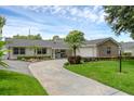 Charming single-story home featuring a well-manicured lawn and a circular driveway at 1850 Geronimo Trl, Maitland, FL 32751