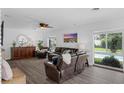 Spacious living room boasts wood-look floors, large windows, and comfortable seating at 1850 Geronimo Trl, Maitland, FL 32751