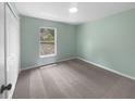 This bedroom offers neutral carpet, a double-door closet, and a window for natural light at 1877 Courtland Blvd, Deltona, FL 32738