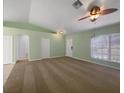 Open living room with carpet, ceiling fan, and natural light at 1877 Courtland Blvd, Deltona, FL 32738