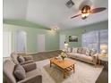 Inviting living room with neutral tones, plush rug, and a ceiling fan for added comfort at 1877 Courtland Blvd, Deltona, FL 32738