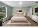 Staged main bedroom with modern decor and ample natural light at 1877 Courtland Blvd, Deltona, FL 32738