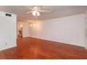Spacious living room boasts wood floors and a ceiling fan and updated lighting at 200 Saint Andrews Blvd # 2607, Winter Park, FL 32792