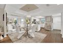 Elegant dining room with a glass table, seating for six, and a stylish chandelier at 240 Killarney Bay Ct # 4, Winter Park, FL 32789