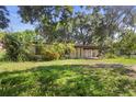 A home with front yard is surrounded by lush mature trees and greenery at 321 Beard Rd, Winter Garden, FL 34787