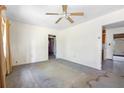 A living room with ceiling fan and multiple access points needing renovation at 321 Beard Rd, Winter Garden, FL 34787