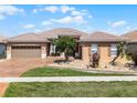 Single-story home featuring a tile roof, a two-car garage, and a decorative, low-maintenance front yard at 3533 Somerset Cir, Kissimmee, FL 34746