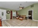Comfortable living room featuring tile floors, a ceiling fan, and neutral décor at 37 Pecan Pass Trl, Ocala, FL 34472