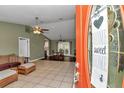 Open-concept living room with tile flooring and views of the dining area and backyard at 37 Pecan Pass Trl, Ocala, FL 34472