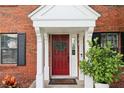 Close-up of the red front door with welcome mat and white trim at 4536 Misty Morn Cir, Orlando, FL 32812