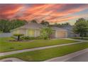 Beautiful single-story home with a well-kept lawn and lush landscaping at 460 Suncrest Ct, Oviedo, FL 32765