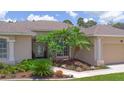Inviting home exterior with a well-manicured garden and walkway at 460 Suncrest Ct, Oviedo, FL 32765