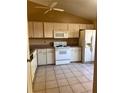 Functional kitchen featuring classic appliances, tile floors, and ample cabinet storage space at 5265 Broken Arrow Dr, Kissimmee, FL 34746