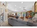 Comfortable living room with neutral colors, a ceiling fan, and large windows at 5704 Bay Side Dr, Orlando, FL 32819