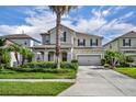 Two-story home showcasing manicured landscaping, a two-car garage and a welcoming front entrance at 7895 Pleasant Pine Cir, Winter Park, FL 32792
