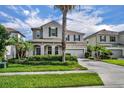 Two-story home showcasing manicured landscaping, a two-car garage and a welcoming front entrance at 7895 Pleasant Pine Cir, Winter Park, FL 32792