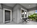 Inviting front porch featuring a covered entrance, neutral colors, and comfortable seating at 7895 Pleasant Pine Cir, Winter Park, FL 32792