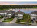 Aerial view of home with lake view and solar panels, complemented by lush greenery at 840 Livestock Loop, St Cloud, FL 34771