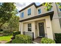 A welcoming two-story home featuring manicured landscaping and a dark-colored front door with a wreath at 9814 Amber Chestnut Way, Winter Garden, FL 34787