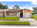 Charming single-story home with well-manicured lawn, neutral paint scheme, and attached one car garage at 999 Mancha Real Dr, Orlando, FL 32807