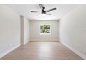 Bright bedroom with a modern ceiling fan, natural light, and fresh, neutral-toned paint at 105 E Magnolia St, Davenport, FL 33837