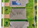Aerial view of neighborhood homes showing roof tops and solar panels at 1156 Cavender Creek Rd, Minneola, FL 34715