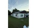 Exterior view of home with a white picket fence and spacious yard at 1425 26Th St, Orlando, FL 32805