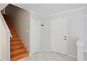 Bright foyer features tile flooring, stairs to the second floor, and a convenient coat closet at 14332 Grassy Cove Cir, Orlando, FL 32824
