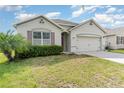 Inviting home with a lush lawn, a two-car garage, and beautiful curb appeal at 1864 Green Dragon Dr, St Cloud, FL 34771