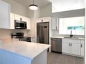 Modern kitchen features stainless steel appliances, white cabinets, and a bright window at 2118 Donegan Pl, Orlando, FL 32826