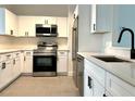 This stylish kitchen boasts stainless steel appliances and sleek white cabinetry for a contemporary feel at 2118 Donegan Pl, Orlando, FL 32826
