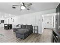 Spacious living room with a comfortable gray sofa, plank flooring, and views of other home areas at 2908 Clear Way, Orlando, FL 32805
