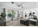 Open-concept living room featuring lots of light, plank flooring, and direct access to a modern kitchen at 2908 Clear Way, Orlando, FL 32805