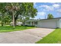 A house with a well-kept lawn and driveway leading to a two-car garage at 323 Scotland Dr, Daytona Beach, FL 32117