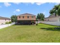 Spacious backyard featuring a screened-in patio and a well-maintained lawn, perfect for outdoor activities at 352 Giovani Blvd, Clermont, FL 34715