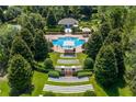 Aerial view of community pool surrounded by manicured gardens and lush landscaping, offering a resort-style experience at 352 Giovani Blvd, Clermont, FL 34715