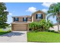 Beautiful two-story home with lush landscaping, attached two-car garage, and inviting curb appeal at 352 Giovani Blvd, Clermont, FL 34715