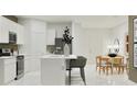 Bright kitchen with an island, sleek appliances, and seamless flow to the dining area at 367 Sol Vista Dr, Dundee, FL 33838