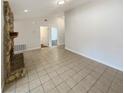 Spacious living room with stone fireplace and tile flooring, ready for personalized touches at 412 Ranch Trl, Casselberry, FL 32707