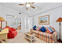 Cozy living room featuring a comfortable sofa and a stylish ceiling fan at 4628 Harbour Village Blvd # 2308, Ponce Inlet, FL 32127