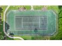 Aerial shot of a fenced-in tennis court showing the court's surface, surrounding trees and pathway around it at 4870 S Semoran Blvd # 1904, Orlando, FL 32822