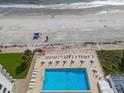 Aerial view of the community pool offering residents a refreshing escape with sun loungers at 5201 S Atlantic Ave # 703A, New Smyrna Beach, FL 32169