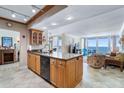 Open kitchen with a kitchen island that flows seamlessly into the living area with views of the ocean at 5201 S Atlantic Ave # 703A, New Smyrna Beach, FL 32169