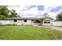 Charming single-story home featuring a well-maintained lawn, tidy landscaping, and a light beige exterior paint at 5300 Locksley Ave, Orlando, FL 32810